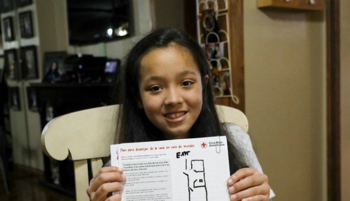 Girl holds up a home fire escape plan that she worked on