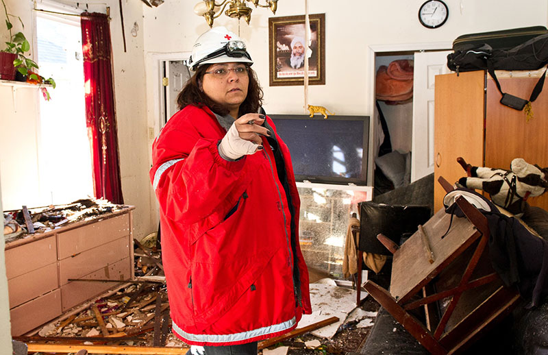 Red Cross volunteer in damaged home