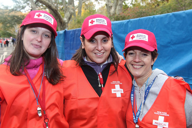 3 Red Cross volunteers smiling for the camera