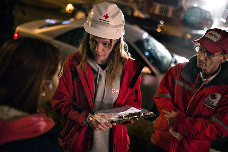 3 Red Cross volunteers speaking with each other