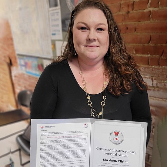 Liz Clifton showing Red Cross Lifesaver Award