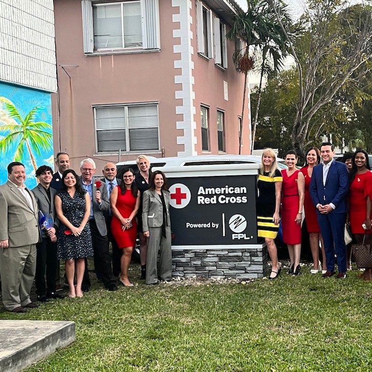 Red Cross personnel posing with new Miami headquarters building sign