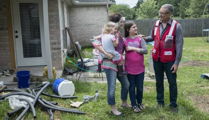 Amanda Garrison shows Marco Bracamontes of the American Red Cross some of her damaged possessions