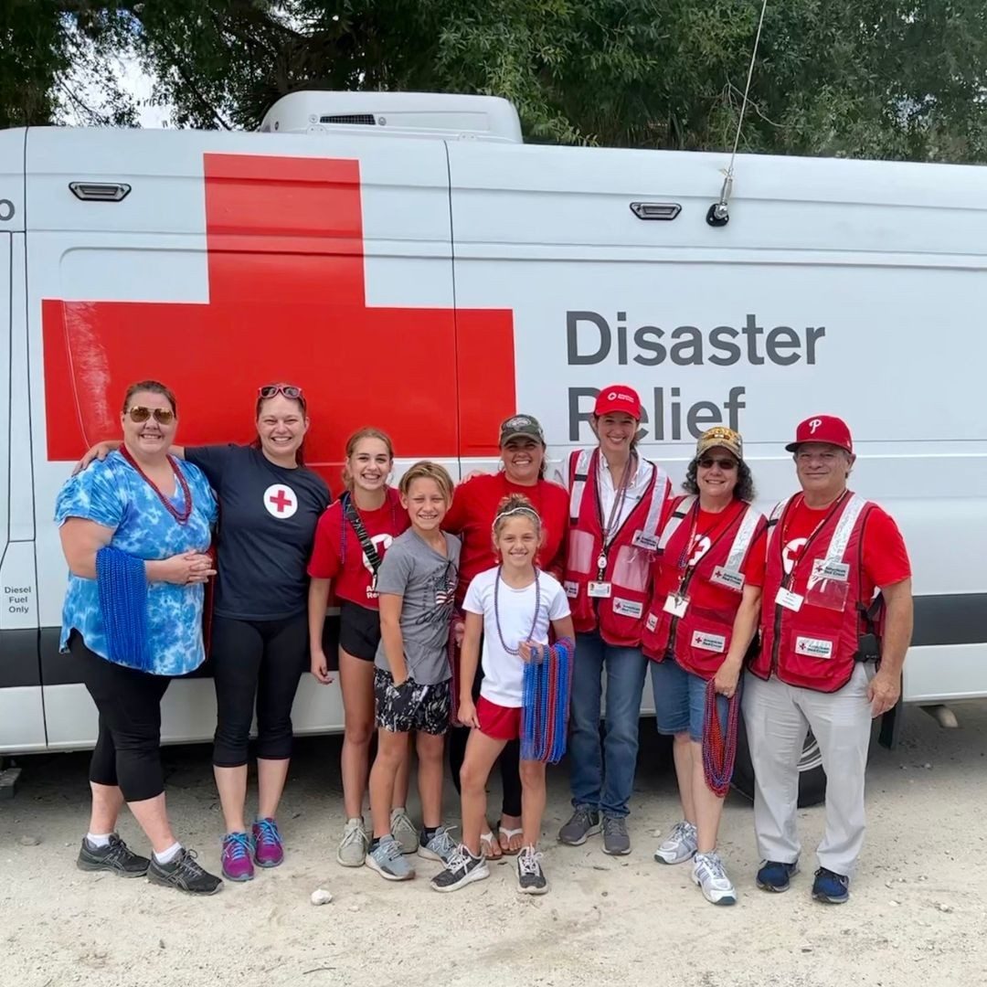 volunteers in front of disaster response vehicle