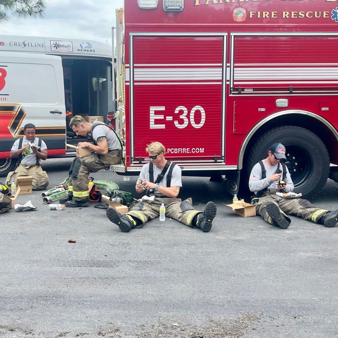 first responders resting in front of fire truck