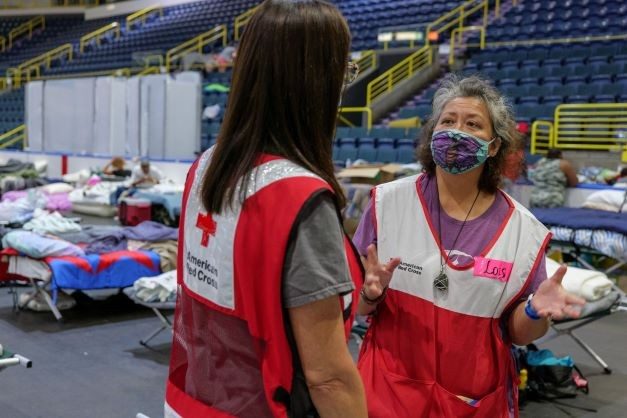 Two Red Cross volunteers talking to each other