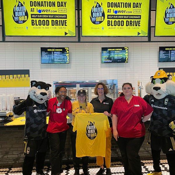 Red Cross volunteers, blood donors and Columbus Crew soccer team mascots group photo. 