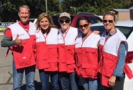 group of five red cross volunteers smiling