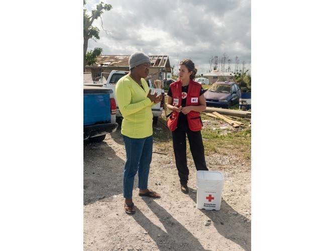 Red Cross relief worker Katie Wilkes listens to Pamela's story of survival