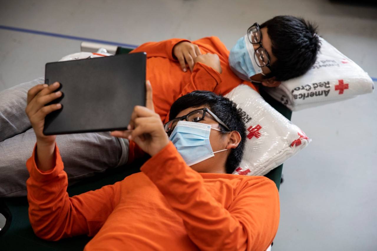 July 28, 2020. Edcouch, Texas
Twins Marcos and Jeremias watch a video while resting at a Red Cross emergency shelter for people displaced by Hurricane Hanna in Edcouch, TX on Tuesday July 28, 2020.
Photo by Scott Dalton/American Red Cross