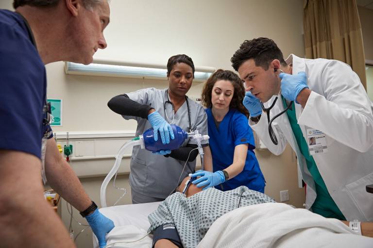 Medical providers demonstrate teamwork while providing advanced life support to a patient.