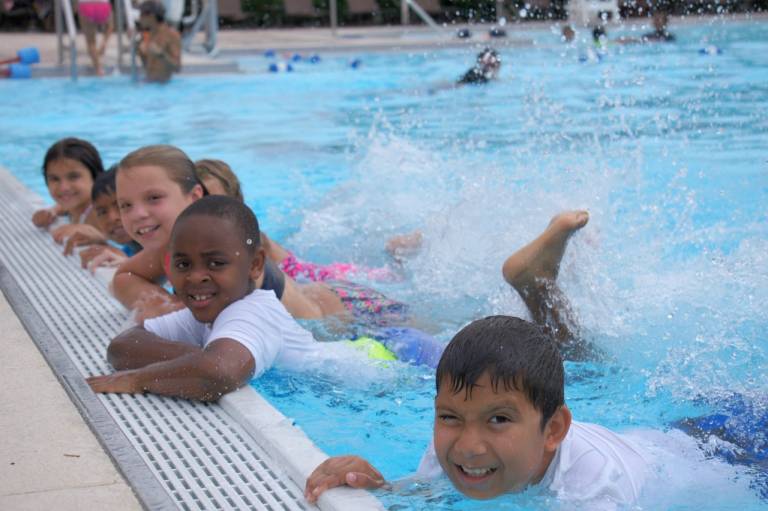 Children happily learning to swim as part of the Aquatics Centennial Campaign. 