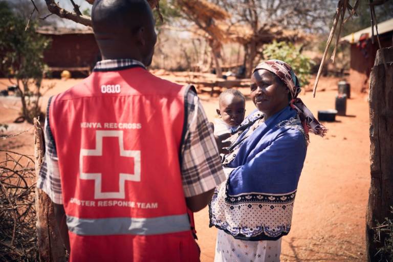 Kenya Red Cross volunteer talks with mom and baby
