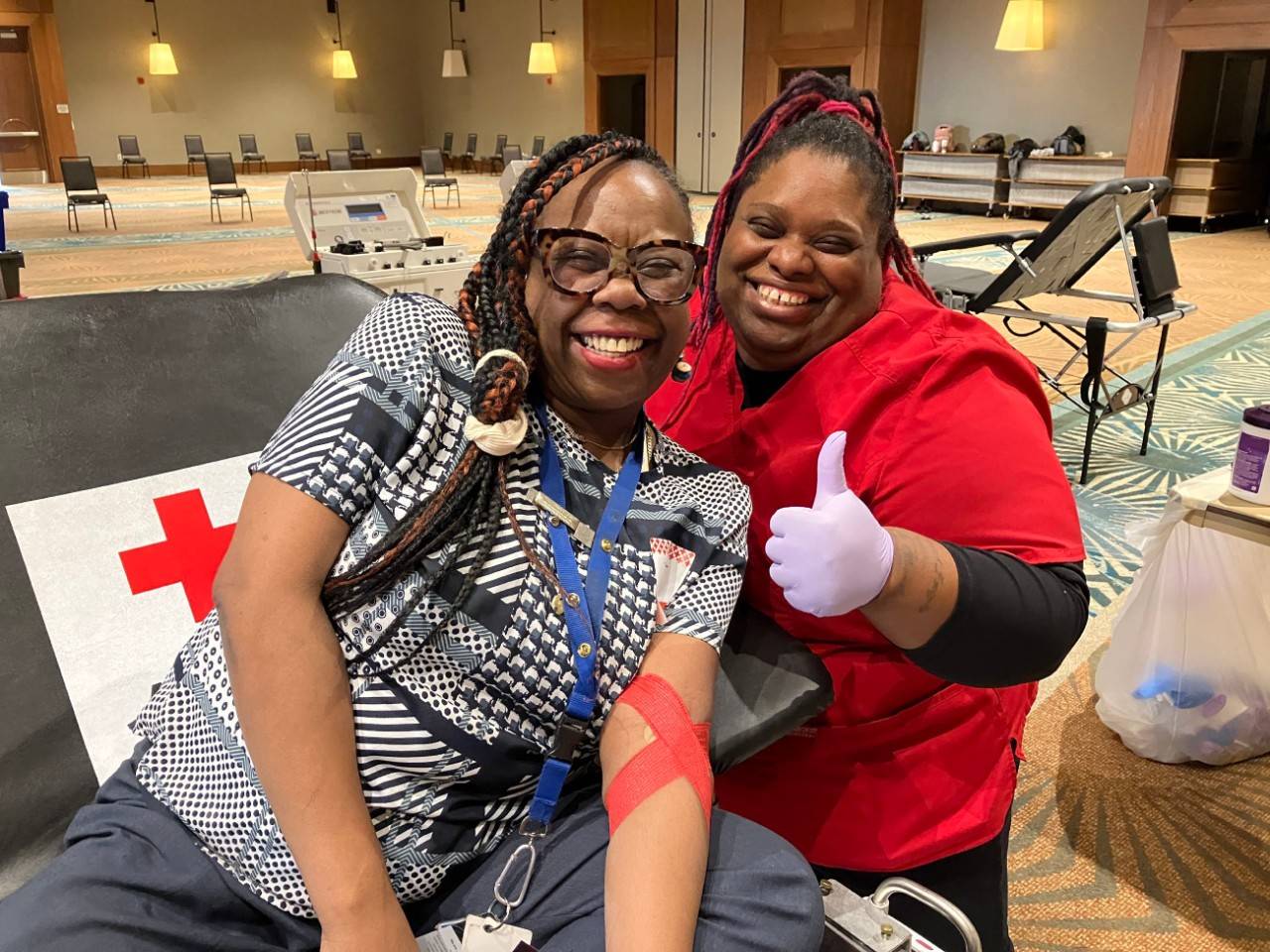 January 11, 2023. Raleigh, NC. Blood Donor Lakeiska Williams of North Carolina donates blood during the ABC11 Together Blood Drive on 1-11-2023 at the Marriott Raleigh Crabtree Valley. Grateful to be a lifesaver, she poses for a photo with Red Cross collection team member Dana Robinson. Photo by Tai Wong/American Red Cross.