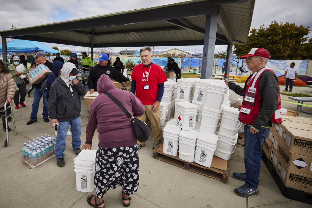 volunteers distribute cleanup supplies
