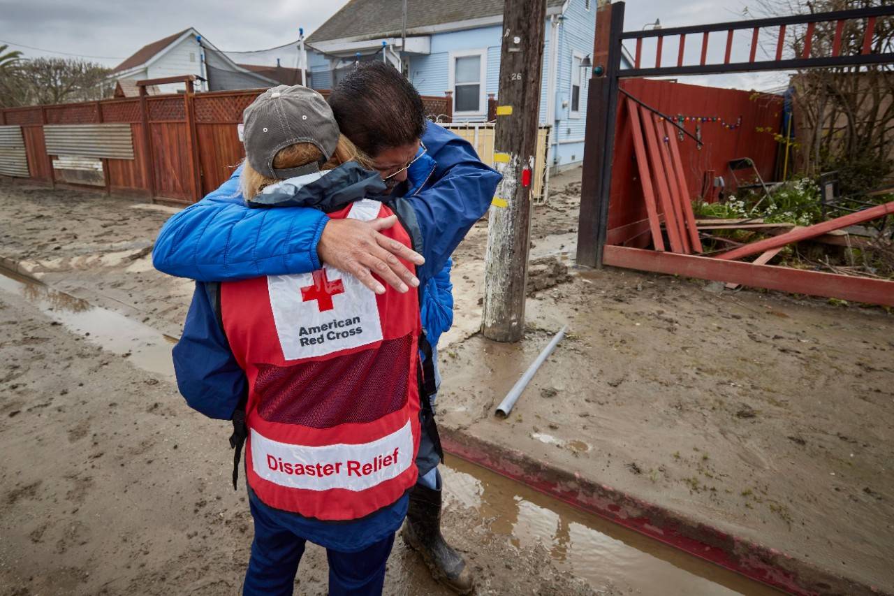 March 23, 2023. Pajaro, California. Gustavo Baez, Pajaro, California homeowner, hugs American Red Cross volunteer, Cindy Huge. and thanks, her, and the many volunteers for caring about his community. Photo by Jaka Vinsek/American Red Cross