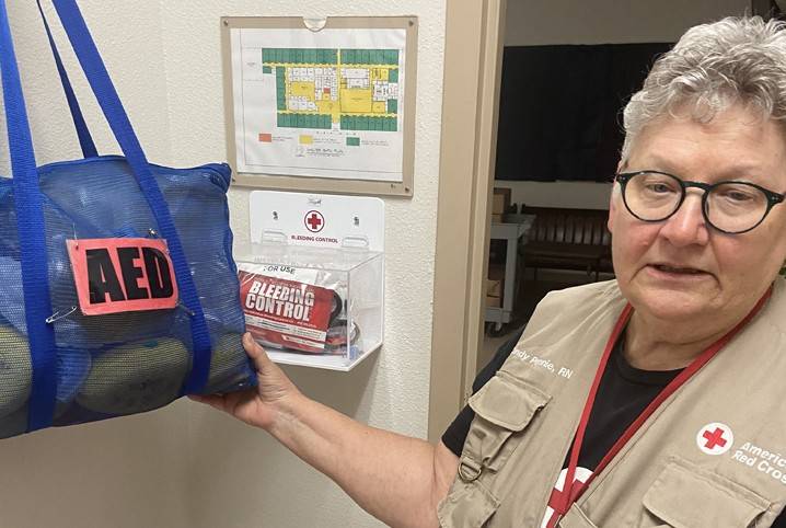 A Red Cross Disaster Health Services Volunteer is showing the AED unit she used to save the life of evacuee in Florida