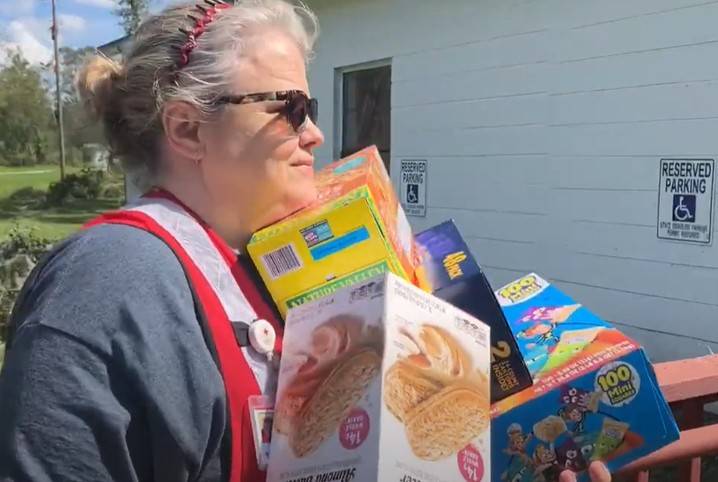 A Red Cross volunteer is delivering much needed supplies to people in need