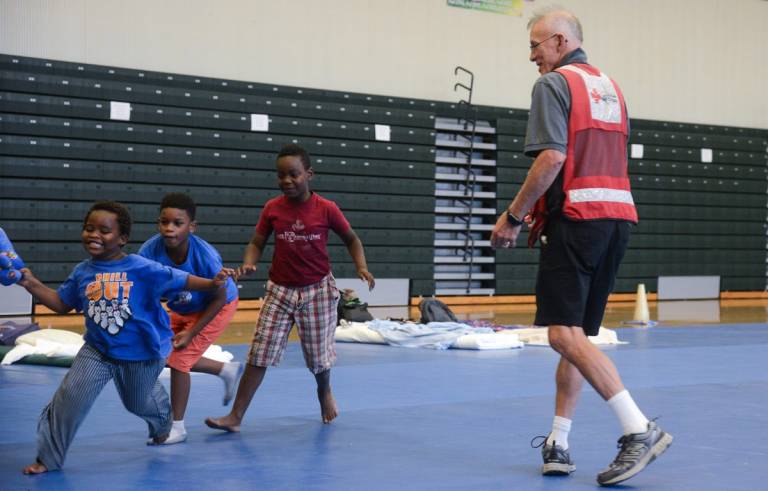 Red Cross volunteer Tom Quinn plays with some of the younger residents 