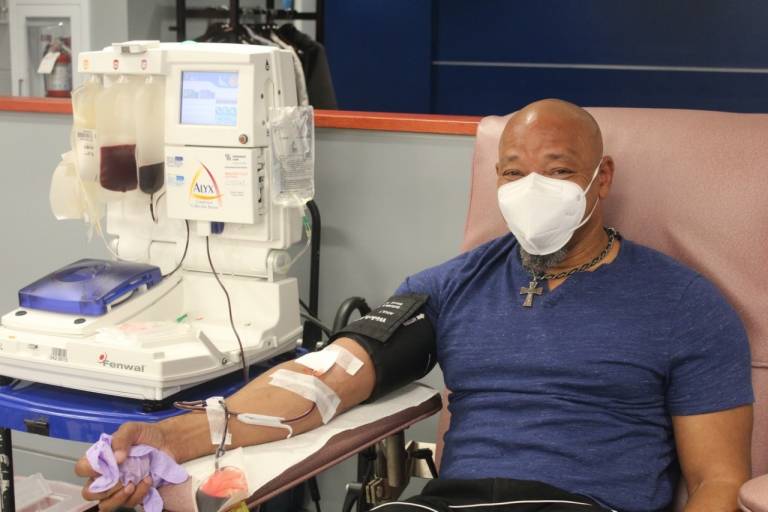 Black man wearing mask donates blood