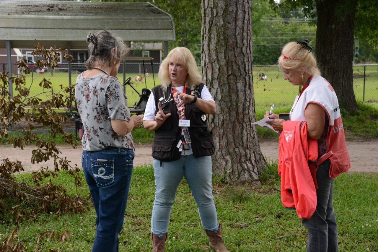 May 15, 2019. Porter, Texas. Disaster mental health volunteer, Shirley Jackson, and nurse volunteer, Liz Miller, speak with Susan Thompson, whose home was damaged when a flood hit Porter, Texas. Photo by Daniel Cima/American Red Cross