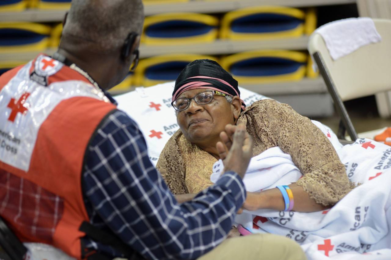 July 14, 2019. Baton Rouge, Lousiana
Red Cross Shelter worker, Waymond Hackney, provides comfort to shelter resident, Beverly Coates.
Photo by Daniel Cima/American Red Cross