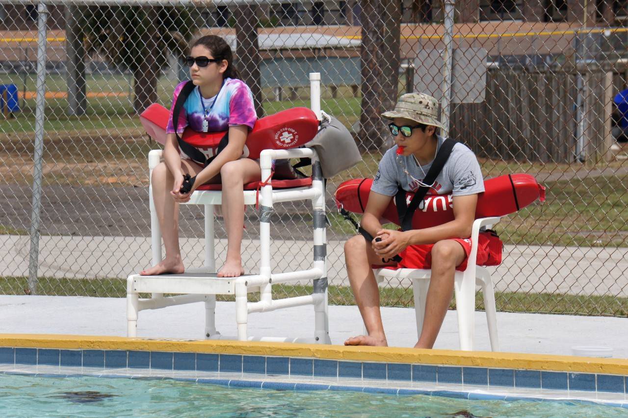 March 27, 2015. Brevard County Parks and Recreation, Florida. Eliana Villarreal, 14, watching over the pool alongside her brother, lifeguard Nino Villarreal, during the "lifeguard shadowing" portion of the Junior Lifeguarding class as part of the Red Cross Centennial Campaign. Photo by Connie Harvey/American Red Cross