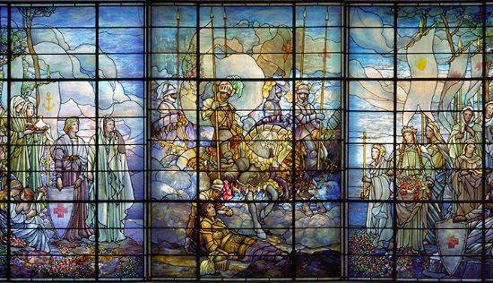 The Tiffany Windows depict the theme of ministry to the sick and wounded through sacrifice..