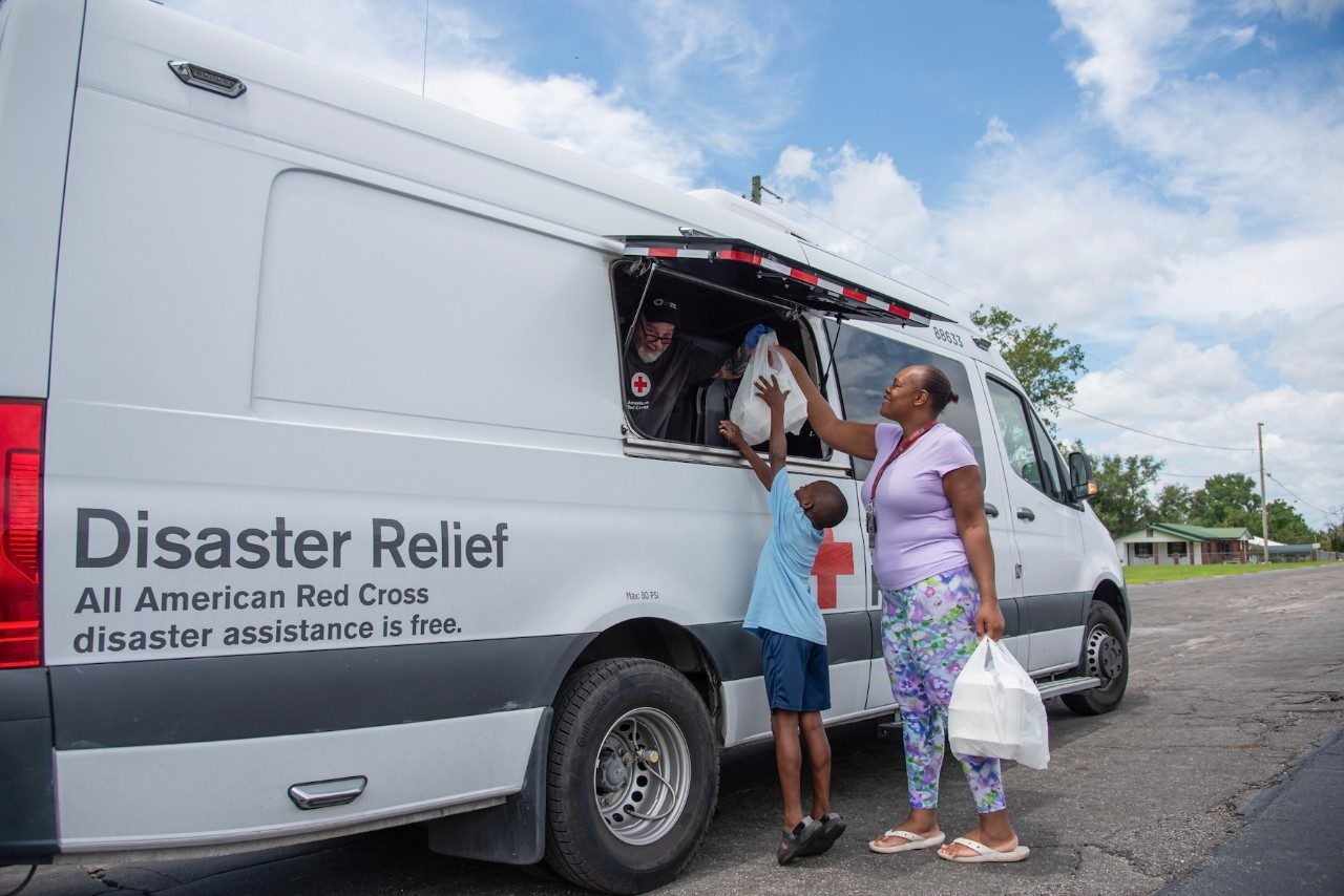 American Red Cross volunteers traveled the neighborhoods of Madison, Florida, serving meals to people like Erica and her eight-year-old son Legend who were affected by Hurricane Debby.