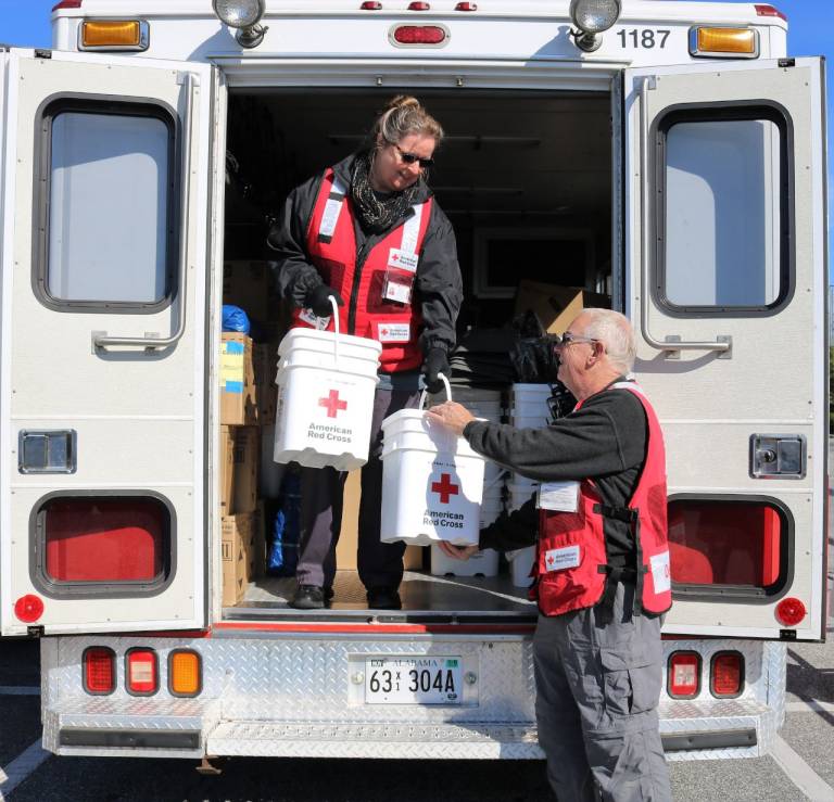 Volunteers Peter Simmons and Jane Jenkins distribute relief supplies in Alabama. Red Cross photo by Ashley Henyan