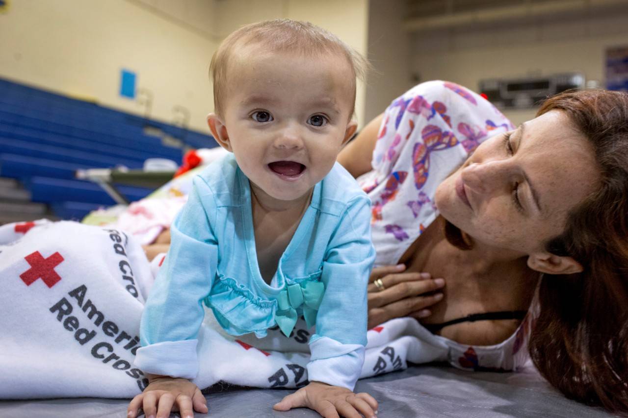 September 16, 2017. The Florida Keys.
Gloria and her daughter Madeleine, 8 months, are staying at the Red Cross shelter in Marathon after Hurricane Irma hit the Florida Keys.  We didn t think it was going to be this bad,  says Gloria. 
Photo by Marko Kokic for The American Red Cross