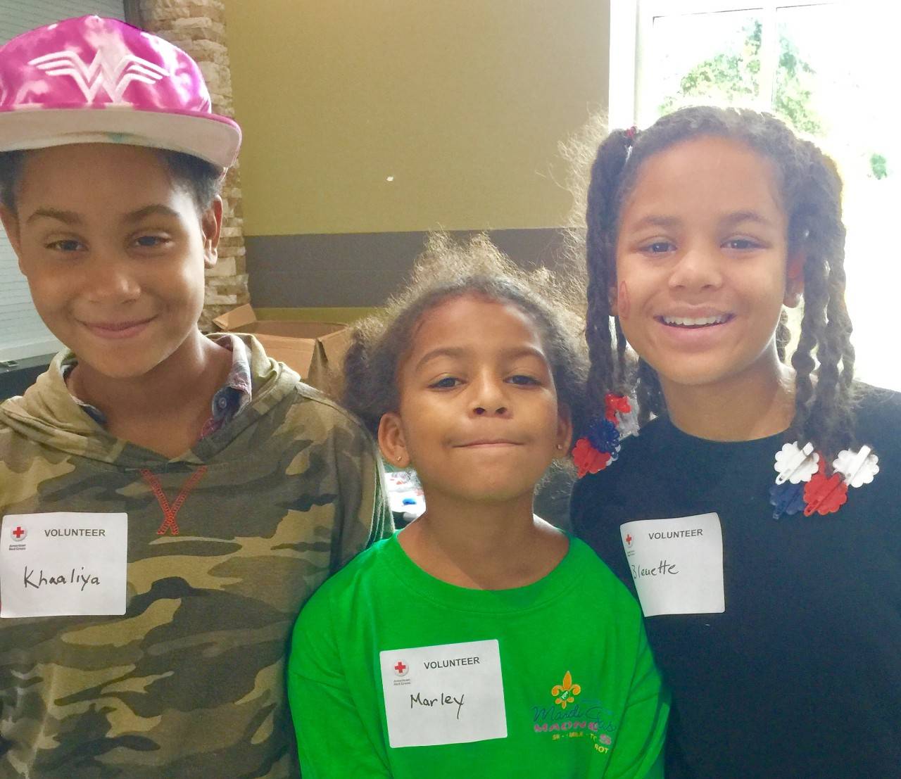 "Wonder girls":  (L-R) Sisters Khaaliya Freire, 12, Marley Hypolitte, 9, and Bleuette Hypolitte, 11, were energetic Red Cross volunteers at the largest population evacuation center in Georgia during Irma. After father Mitchell Robinson started volunteering, the sisters wanted in and picked up trash and worked at the snack table at the Columbus (GA) Civic Center, which hosted nearly 600 residents.  Center manager Heidi Bassano called them her "wonder girls."