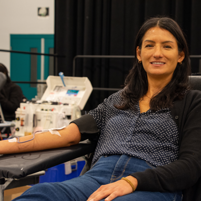 A woman donates blood at a Red Cross blood drive