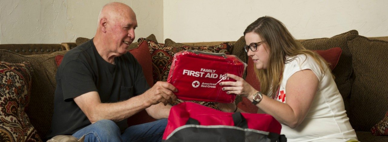 volunteer assisting resident with first aid kit