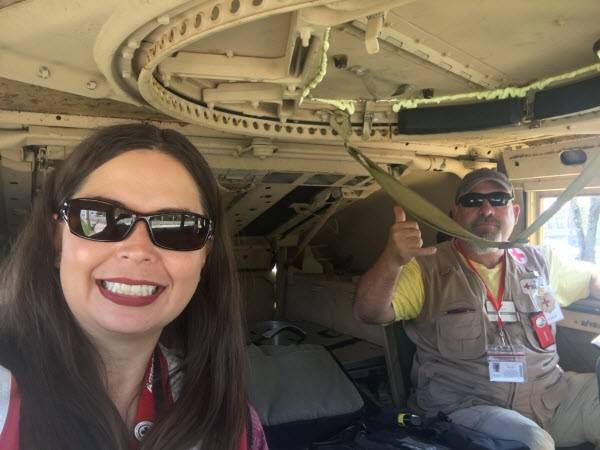 Red Cross volunteer LayLa Johnson rides in military humvees 