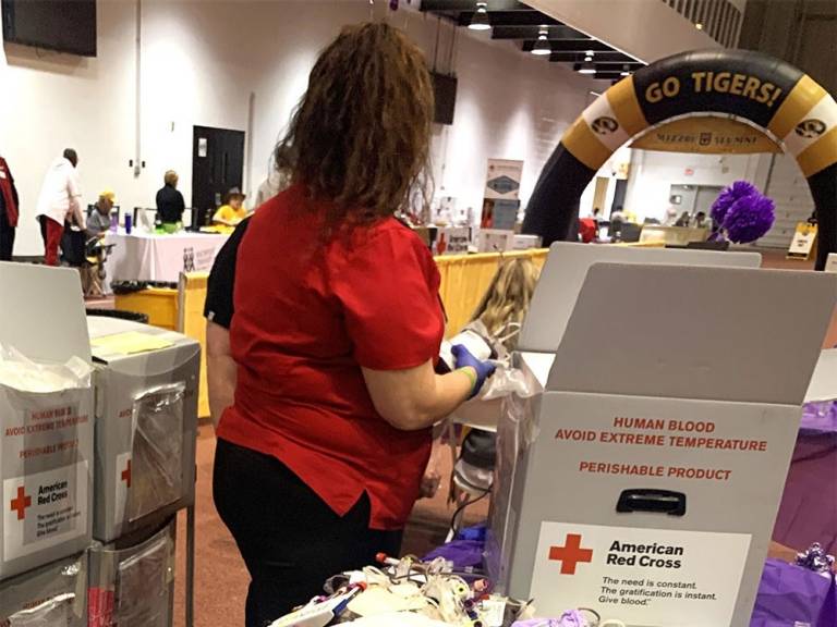 Red Cross bio-med technician packages units of donated blood