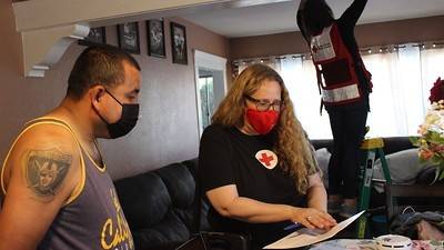 Red Cross volunteer going over escape plan with resident