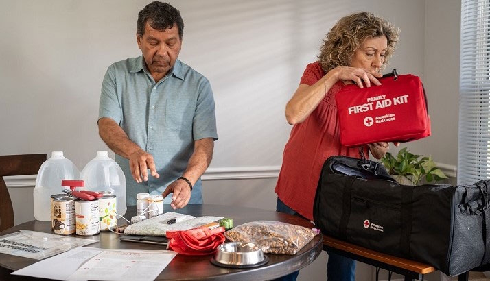 Two people packing food and supplies.