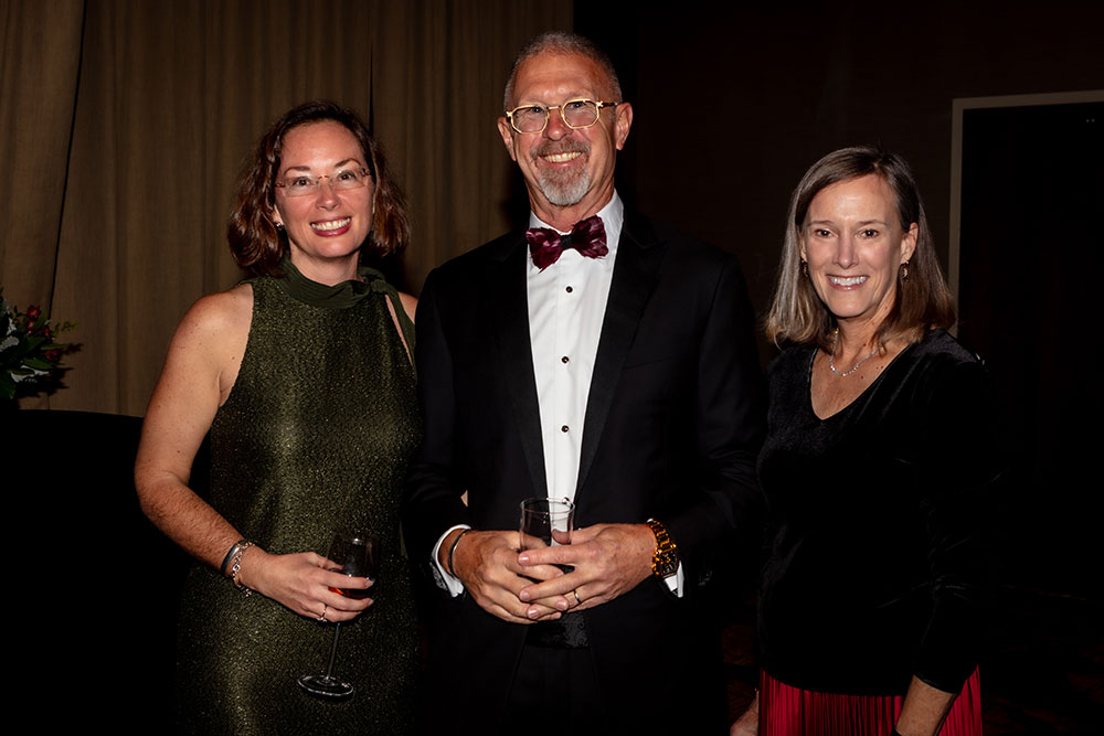 Three people pose for a picture at the Red Cross Gala.