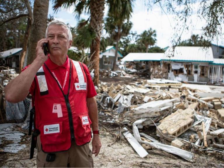 volunteer on phone at scene of damage