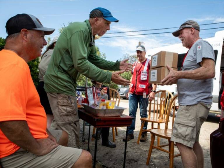 volunteers handing out water to civilians