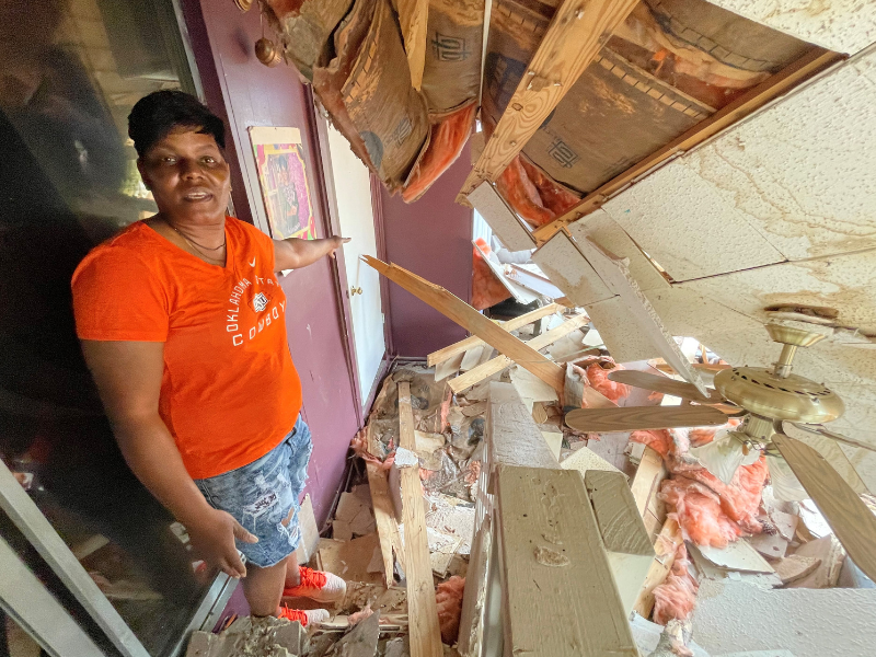 Salynthia Walls in front of damage to home