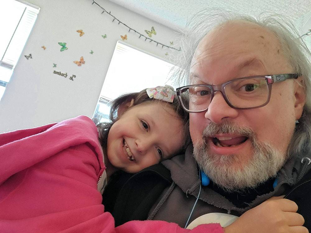 Donald Ellett cuddles with his granddaughter Aurora.