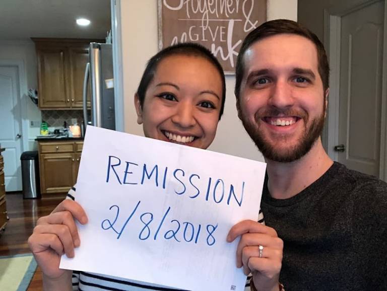 Stephenie holding sign that says remission 2/28/2018