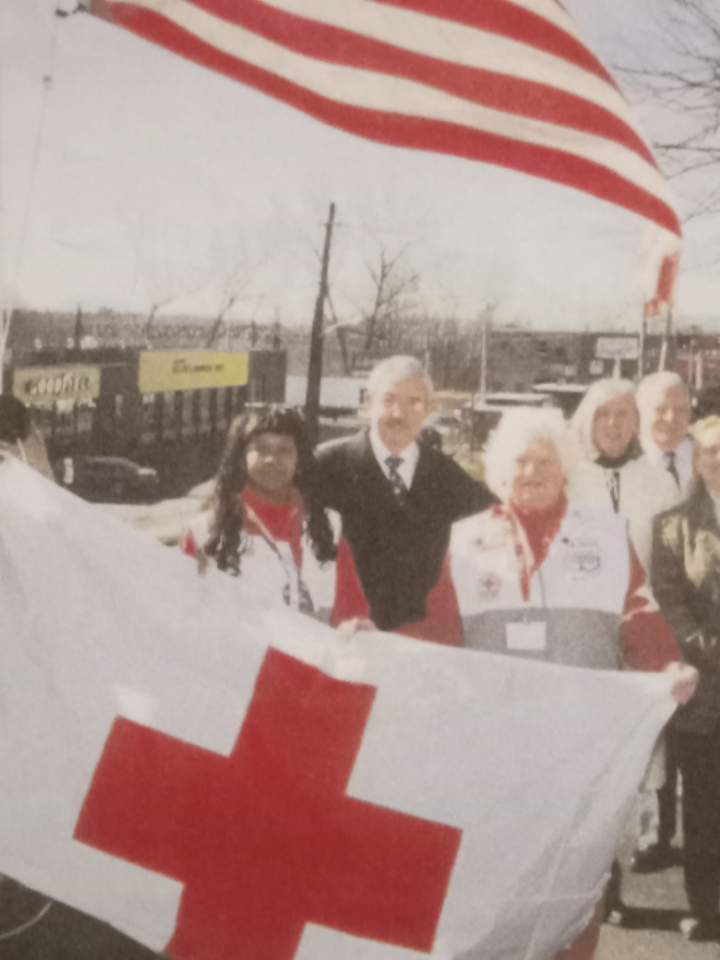 grace young holding red cross flag