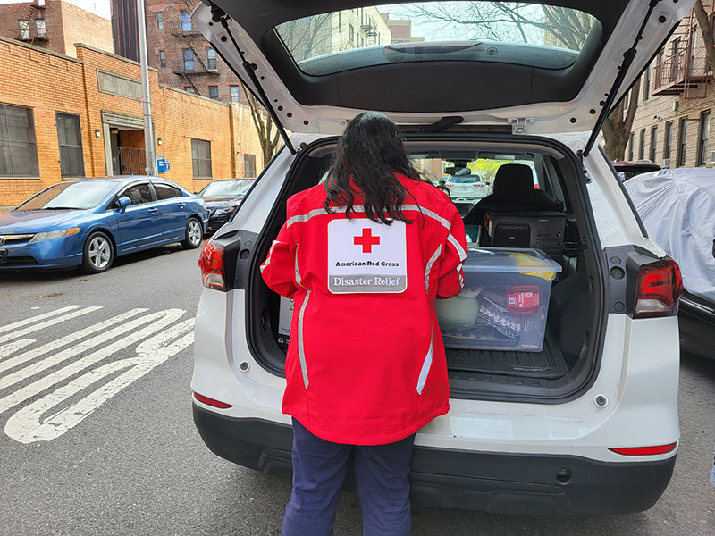 Red Cross worker unloads car full of donations