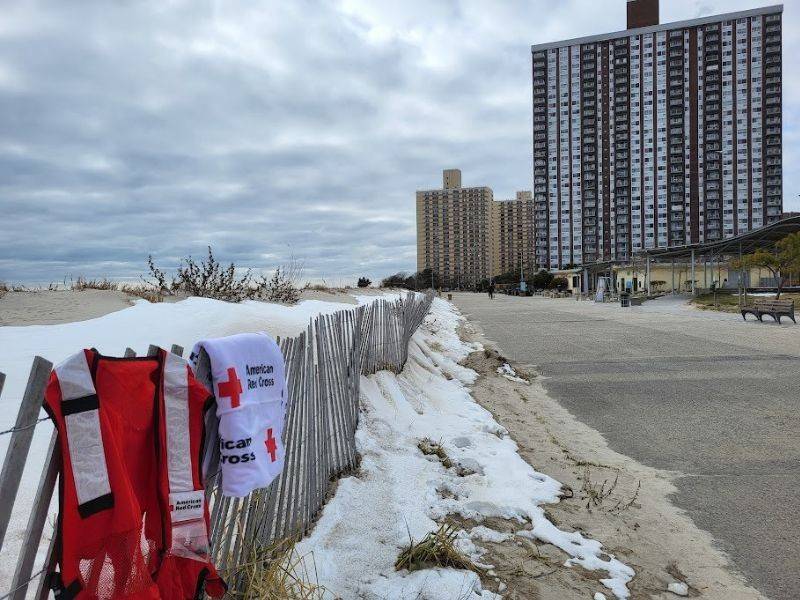 atlanta ocean shorefront with red cross blanket on fence
