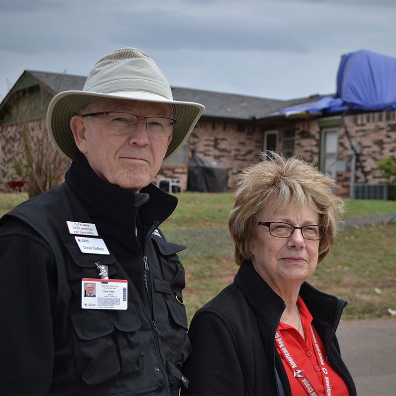 David and Barbara Delker with house in background.