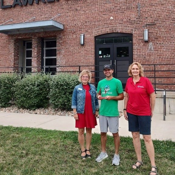 Susan Faler (left), Lawrence Beer Co. owner and inaugural Lawrence Battle of the Breweries winner Matt Williams, and Red Cross volunteer Janet Stallard stand for a photo in front of the brewery.