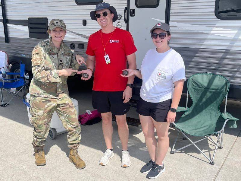 U.S. service member standing with red crossers